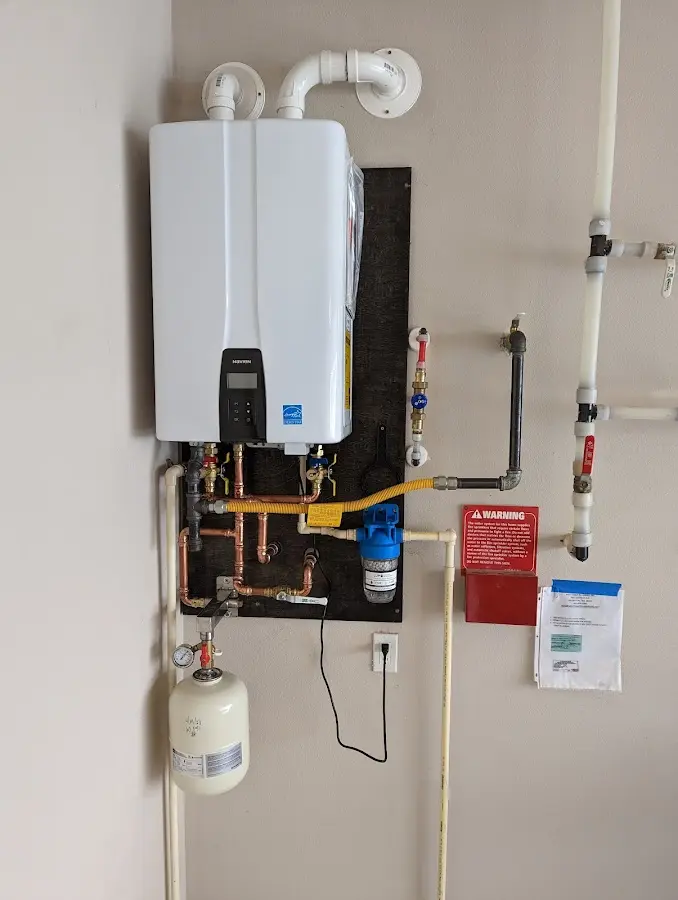 Professional plumber installing copper piping in a Asheville home